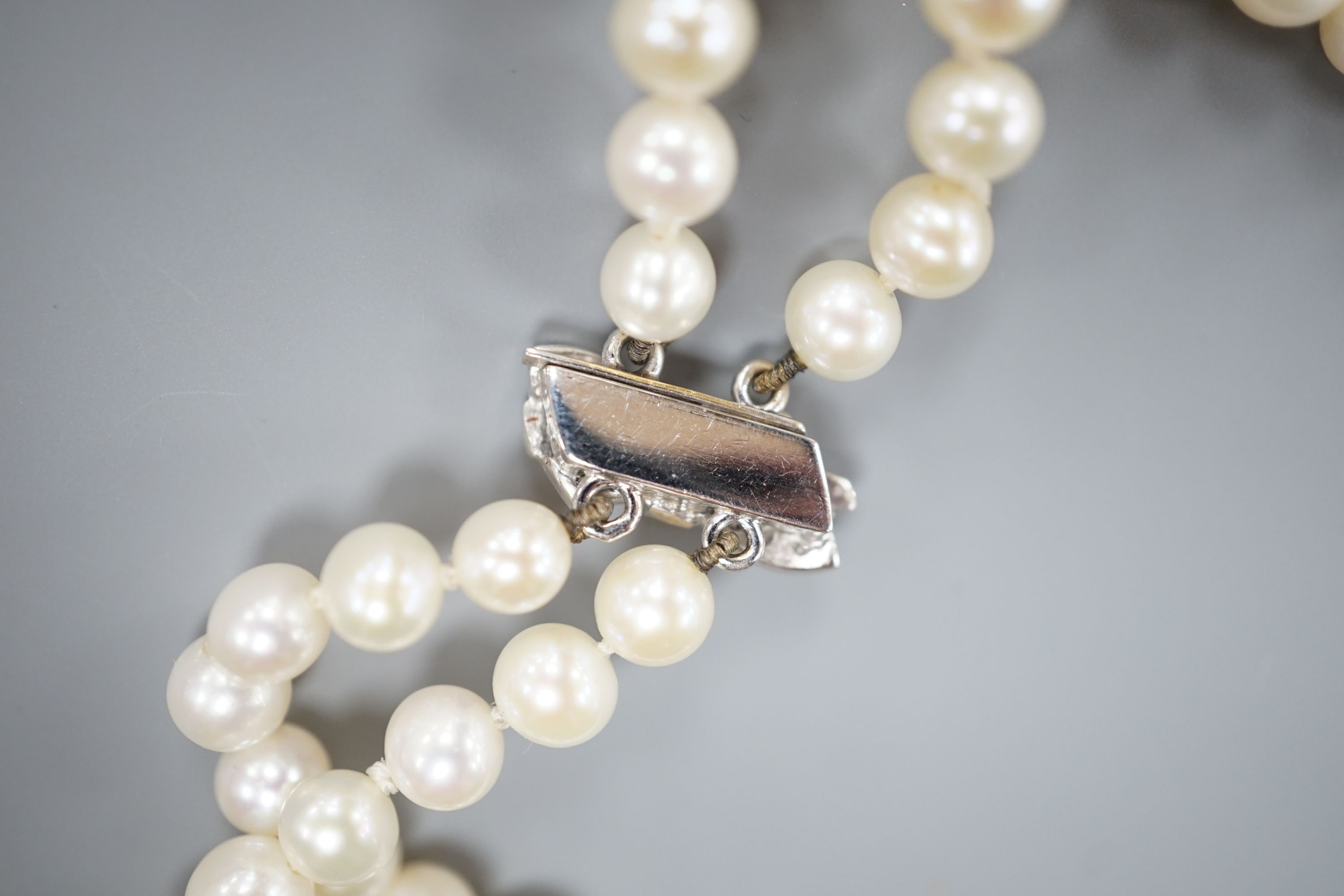 A Portuguese double strand cultured pearl necklace, with diamond set 800 finesse white metal clasp, 23.5cm.